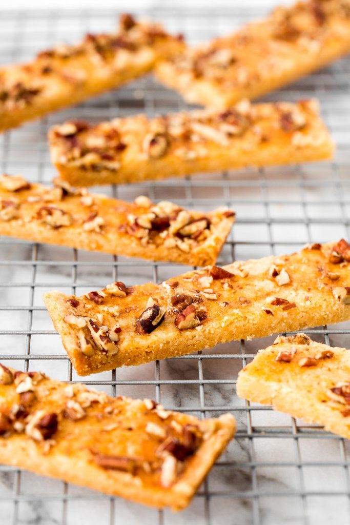 Pecan shortbread bars are delicious strips of buttery shortbread topped with crunchy nuts. Prepped in under 10 minutes with only 6 simple ingredients. | bakehousedesserts.com