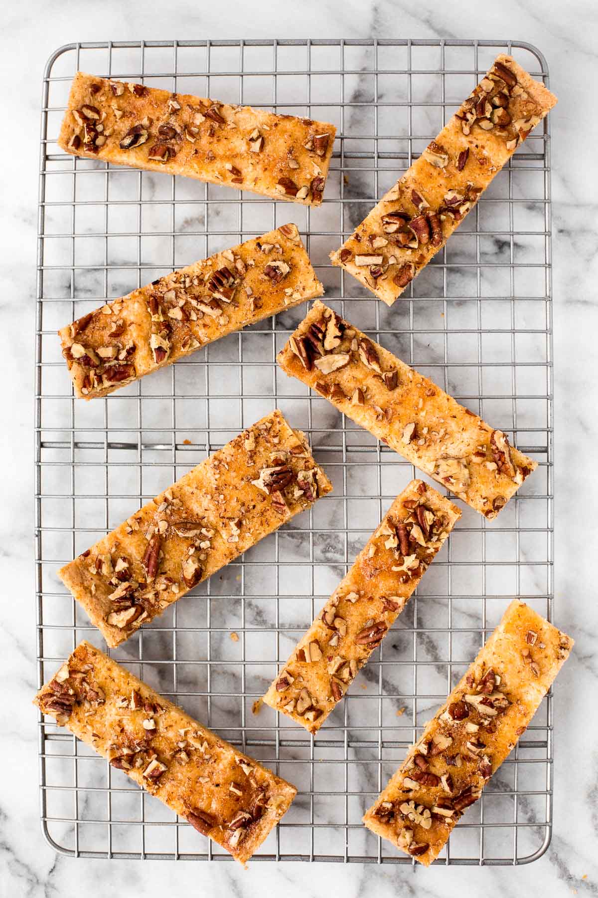 Pecan shortbread bars are delicious strips of buttery shortbread topped with crunchy nuts. Prepped in under 10 minutes with only 6 simple ingredients. | bakehousedesserts.com